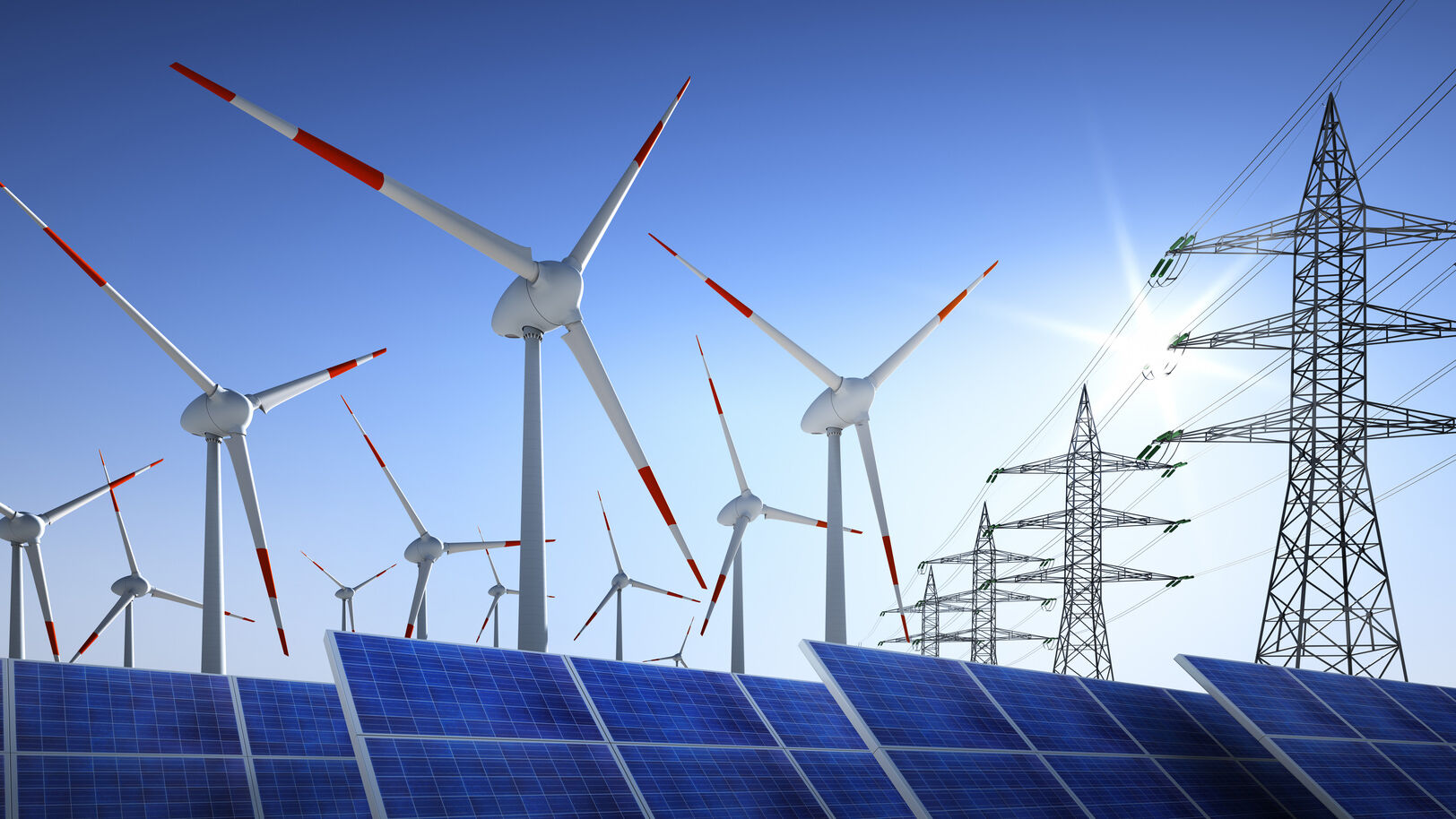 Solarmodule Windkraftraeder und Stromleitungen vor blauem Himmel