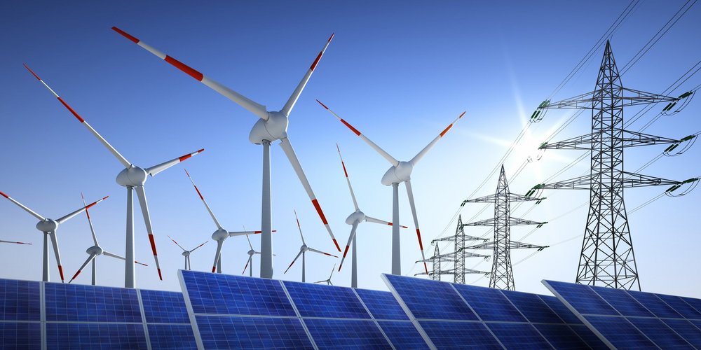 Solarmodule Windkraftraeder und Stromleitungen vor blauem Himmel