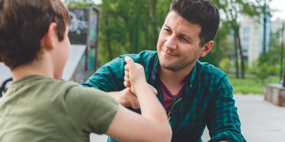 Junge und Mann begrüßen sich freundlich