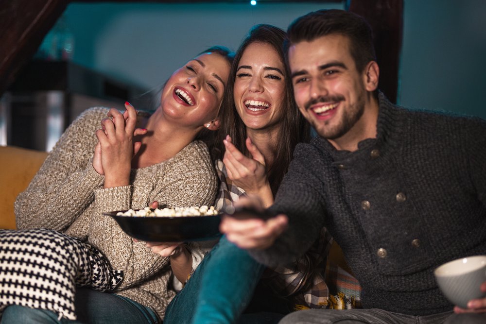 Gruppe die einen Film zusammen anschaut und Popcorn isst