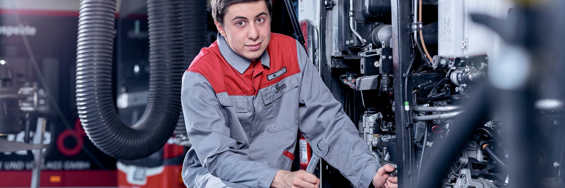 Ausbildung KFZ Mechatroniker- Azubi repariert ein Fahrzeug
